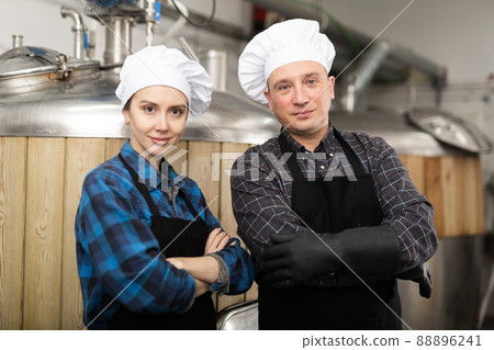 Portrait of man and woman brewmasters in beer factory Portrait of man and woman brewmasters in beer factory 88896241