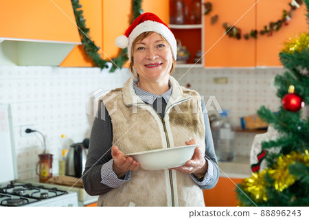 Mature woman standing in kitchen 88896243