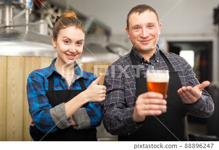 Man and woman - brewery owners with glasses of beer Man and woman - brewery owners with glasses of beer 88896247