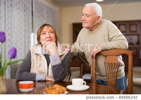 Senior man asking for forgiveness from offended wife Senior man asking for forgiveness from offended wife 88896292