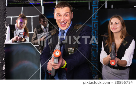 Businessman playing laser tag 88896754