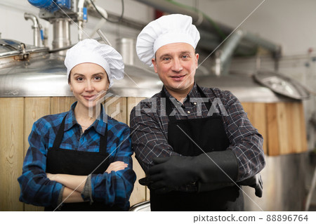 Portrait of man and woman brewmasters in beer factory 88896764