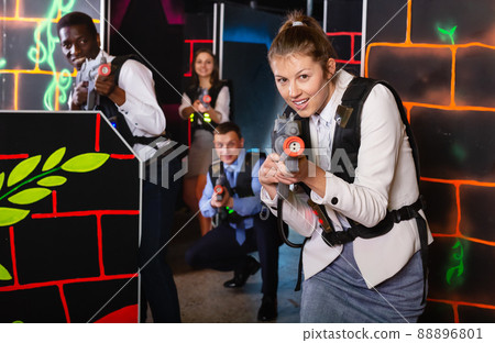 Woman holding laser gun and playing laser tag 88896801