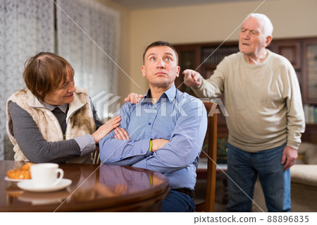 Senior man scolding his adult son 88896835