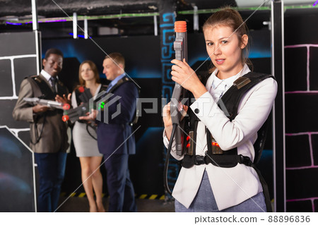 Woman holding laser gun and playing laser tag 88896836