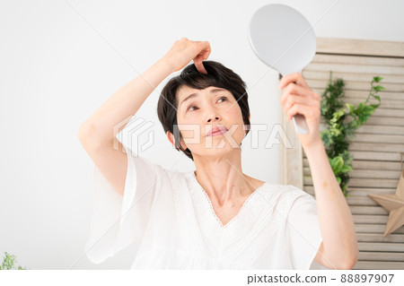 Senior female doing hair care Senior female doing hair care 88897907