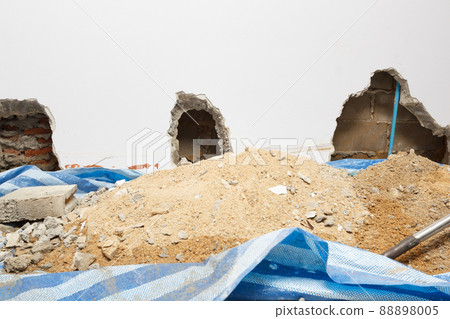 Concrete walls in the shade that have been smashed or destroyed to find holes for water leaks. Home repair concept. 88898005
