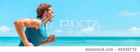 Runner man athlete running on blue ocean and sky banner landscape . Sport active fitness lifestyle panoramic background. Beach run guy profile portrait 88898738