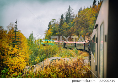 White Pass and Yukon route railroad train ride on old transport rails in Alaska, USA. Nature landscape of Alaska travel cruise excursion. White Pass and Yukon route railroad train ride on old transport rails in Alaska, USA. Nature landscape of Alaska travel cruise excursion. 88900239