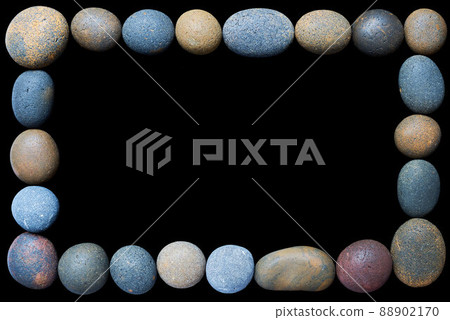A frame of coloured pebbles on a black background A frame of coloured pebbles on a black background 88902170