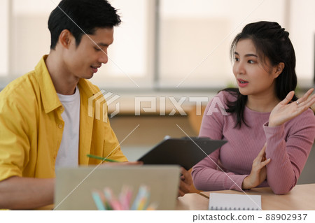 Male and female university students talking and sharing ideas Male and female university students talking and sharing ideas 88902937