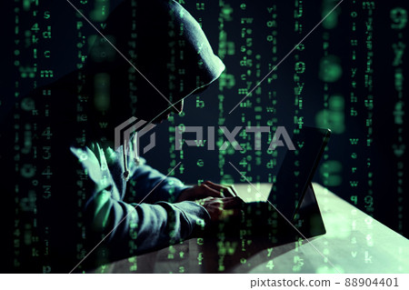Male hacker writing code on a laptop 88904401