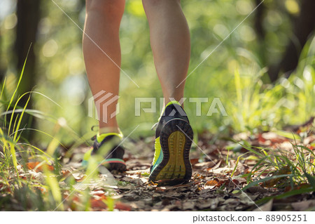 Woman runner running on forest trail 88905251