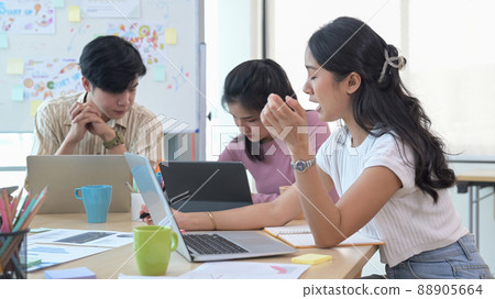 Young business team brainstorming and planning project strategy together at co working space. 88905664
