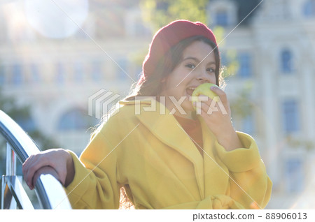 A delicious crunchy apple. Little girl biting into juicy green A delicious crunchy apple. Little girl biting into juicy green 88906013