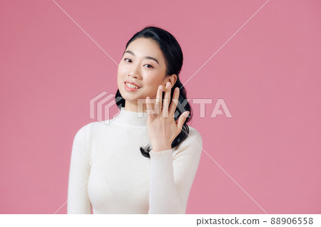 Happy young lady in a headshot showing off her engagement ring Happy young lady in a headshot showing off her engagement ring 88906558