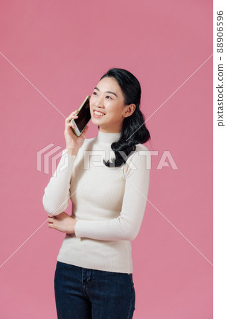 Portrait of happy asian woman talking on mobile phone 88906596