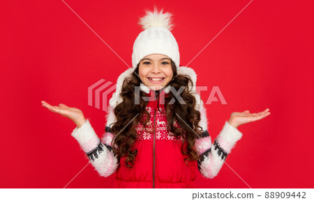 express positive emotion. winter fashion. presenting copy space. happy kid with curly hair express positive emotion. winter fashion. presenting copy space. happy kid with curly hair 88909442