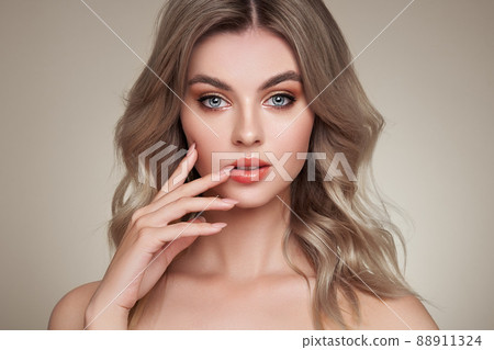 A beautiful young woman with shiny wavy blonde hair 88911324