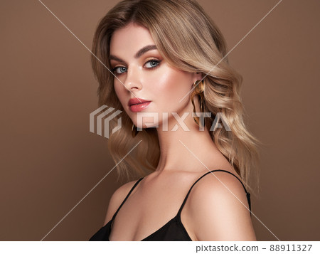 A beautiful young woman with shiny wavy blonde hair A beautiful young woman with shiny wavy blonde hair 88911327