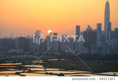 Shenzhen skyline , with skyscrapers and office against fish farm or fish ponds, during dramatic moment in evening, from the view of boundary of Hong Kong suburb where is named Ma Tao Lung 88911961