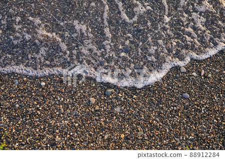 Sea wave on a pebble beach Sea wave on a pebble beach 88912284