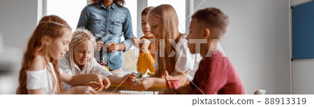Happy boys and girls using wooden math tablet Happy boys and girls using wooden math tablet 88913319