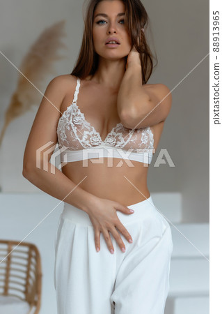 Seductive female taking off pajama pants 88913965