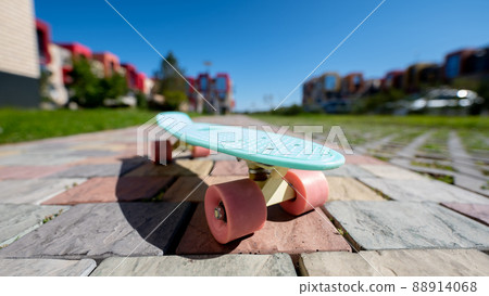 Close-up of a penny board outdoors on a warm summer day. Close-up of a penny board outdoors on a warm summer day. 88914068
