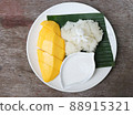 Sweet mango with sticky rice in the white plate topping with Jasmine flower, cuisine of Asia for summer  88915321