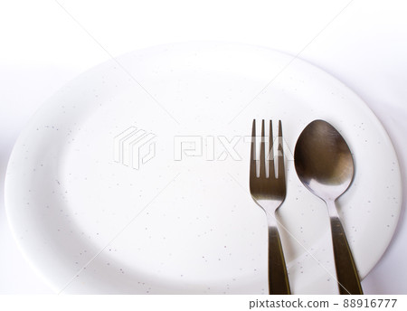 Empty plate and spoon and fork 88916777