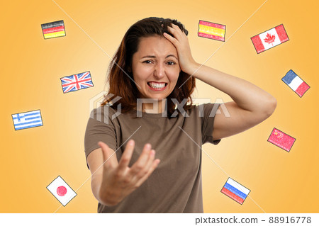 Concept of learning foreign languages. A young woman clutches her head, experiencing stress and difficulties in learning a foreign language. On a yellow background, the flags of different countries 88916778