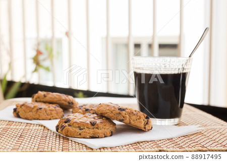 cookies with chocolate and hazelnuts and coffee are on table 88917495