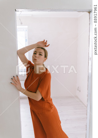 Portrait of young caucasian woman in red cloth. 88917961