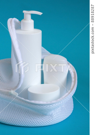 Various cosmetic products with deodorant. Beauty care accessories, shaving set with razor and shaving cream on blue background. 88918287