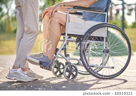 Close up picture of a man sitting in a wheel chair 88919321