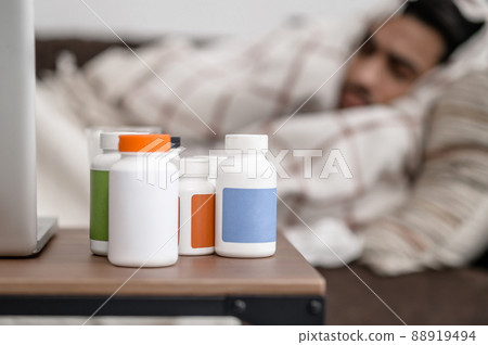 A sick man lying in bed and napping A sick man lying in bed and napping 88919494