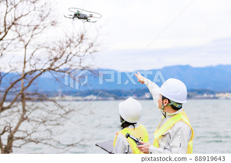 Workers operating drones Workers operating drones 88919643