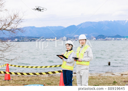 Workers operating drones 88919645
