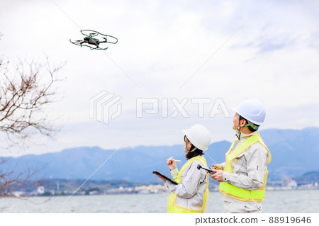 Workers operating drones 88919646