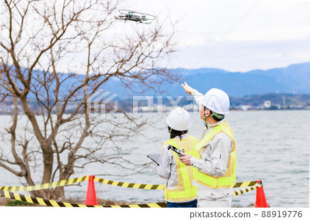 Workers operating drones Workers operating drones 88919776