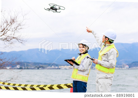 Workers operating drones Workers operating drones 88919801