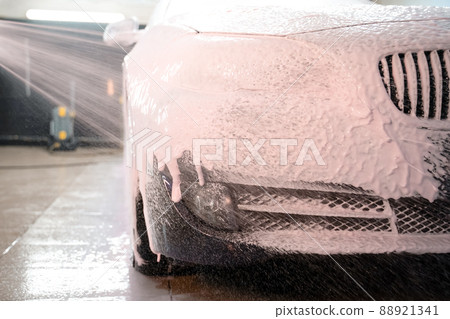 Applying foam to the car. Professional auto wash Applying foam to the car. Professional auto wash 88921341