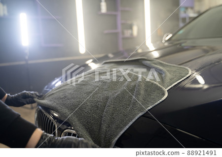 Car wash worker wipes the car after washing with microfiber towel. Professional car wash Car wash worker wipes the car after washing with microfiber towel. Professional car wash 88921491