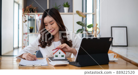 Close up of Business woman pointing and signing agreement for buying house. Bank manager concept. Close up of Business woman pointing and signing agreement for buying house. Bank manager concept. 88922520