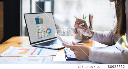 Asian Business Woman or Accountant do math and analyze with calculator and paperwork on desk, account, consult, audit and saving concept. Asian Business Woman or Accountant do math and analyze with calculator and paperwork on desk, account, consult, audit and saving concept. 88922532