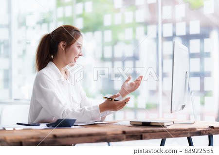 Job interview concept. Business woman questioning and listen to candidate answers during interview by video call on desktop computer. Job interview concept. Business woman questioning and listen to candidate answers during interview by video call on desktop computer. 88922535