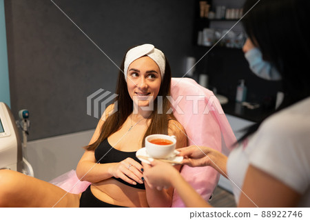 Client of a beauty salon is treated to a cup of tea 88922746