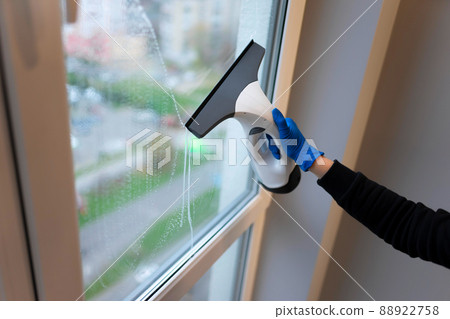 Window cleaning with electric vacuum cleaner. Clean windows concept Window cleaning with electric vacuum cleaner. Clean windows concept 88922758