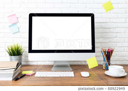 computer with blank white screen mockup, and office supplies on a wooden desk 88922949